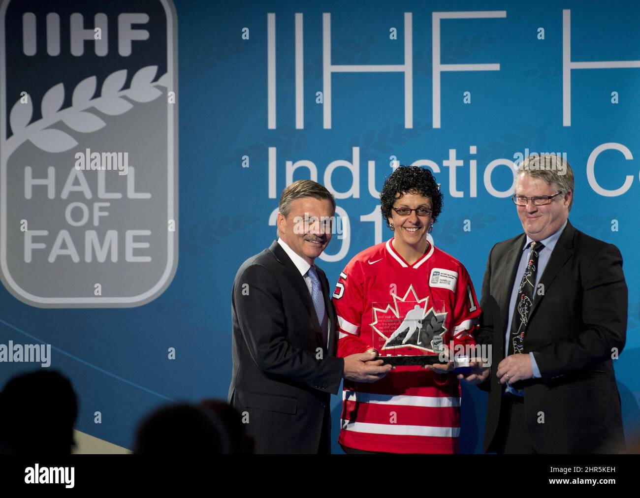 Former Canadian national team member Danielle Goyette, flanked by IIHF president Rene Fasel, left, and former coach of the Swedish women national team, Peter Elander, is inducted at the IIHF Hall of Fame at the world hockey championship in Stockholm Sweden, Sunday, May 19, 2013. THE CANADIAN PRESS/Jacques Boissinot Stock Photo
