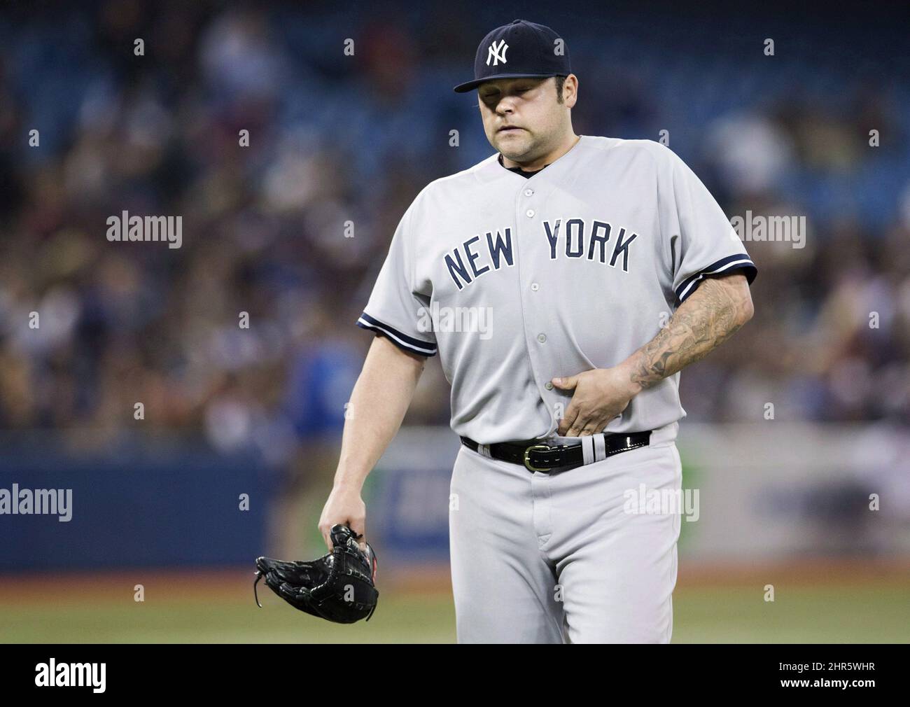 New York Yankees' Joba Chamberlain walks off the mound after being pulled against the Toronto Blue Jays during the seventh inning of MLB American League baseball action in Toronto, Thursday September 19, 2013. THE CANADIAN PRESS/Mark Blinch Stock Photo