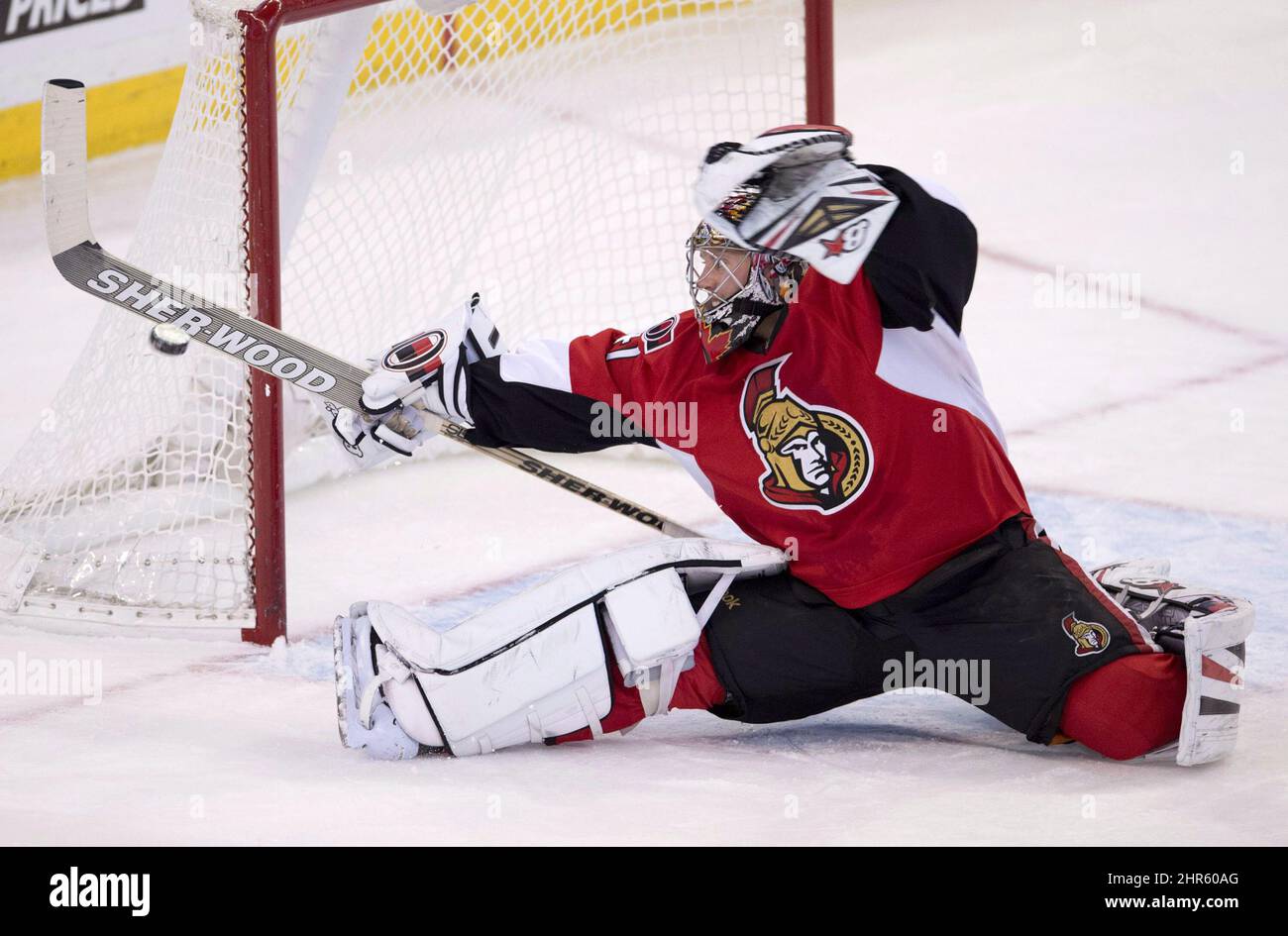 Ottawa Senators goalie Craig Anderson stops a shot with his stick during second period NHL action against the Philadelphia Flyers Tuesday November 12, 2013 in Ottawa. Anderson allowed five goals on 31 shots as the Flyers defeated the Senators 5-0. THE CANADIAN PRESS/Adrian Wyld Stock Photo