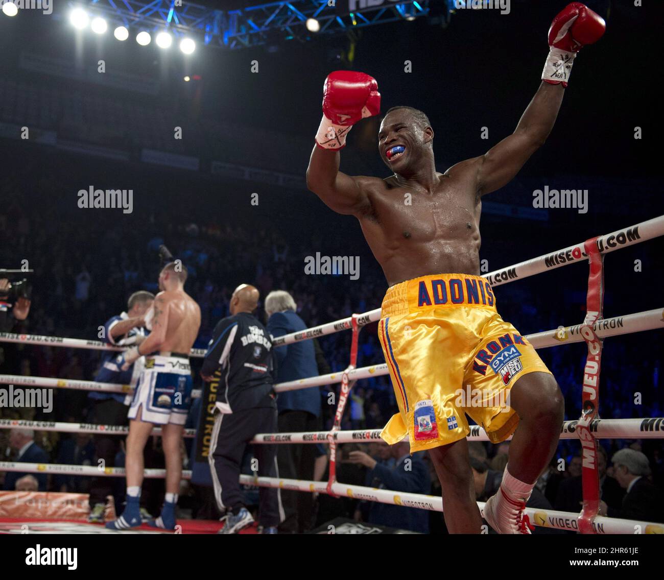 Adonis Stevenson, of Montreal, celebrates his victory against Tony Bellew,  left, of Liverpool, England, after their WBC light heavyweight world  championship fight in Quebec City, Sunday, December 1, 2013. Jean Pascal,  Stevenson,