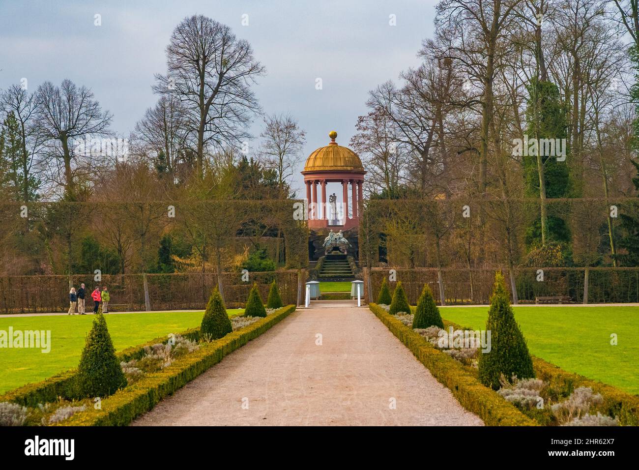 Beautiful panoramic view of the Apollotempel (temple of Apollo) seen on the gravel walkway at the old orangery parterre in the garden of the famous... Stock Photo