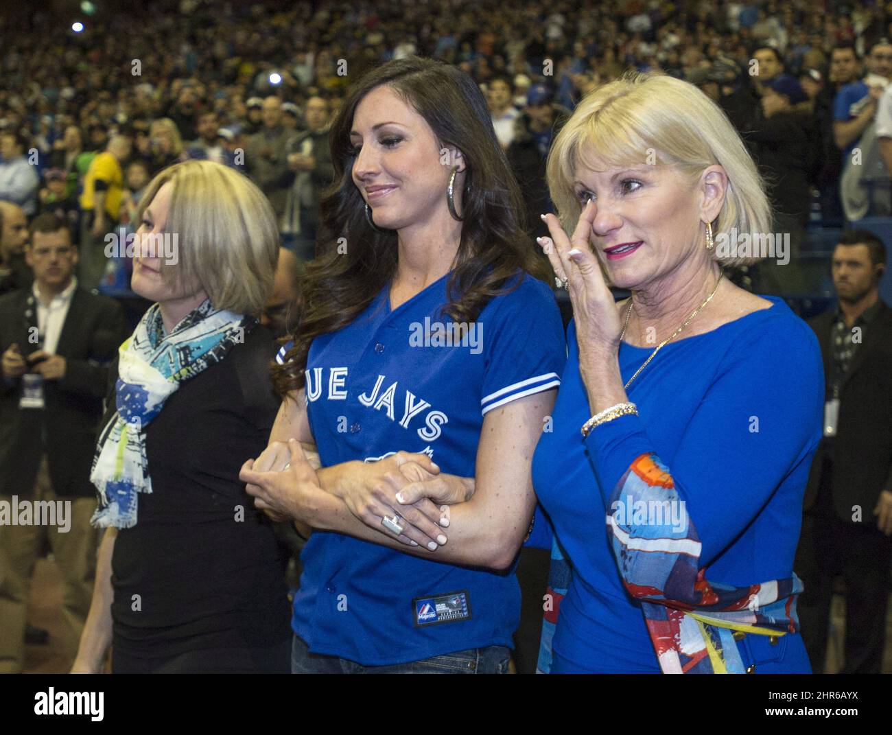 Sandy Carter, wife of former Montreal Expos Gary Carter, wipes her eye as  she and her daughter Kimmy, left, are introduced during a ceremony prior to  a pre-season game between the Toronto