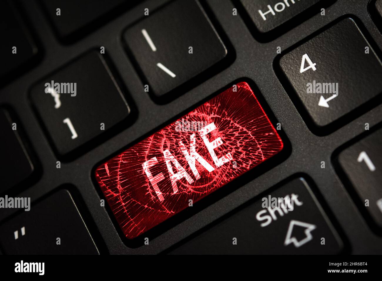 Message on broken red enter key of keyboard. Computer fake news attack