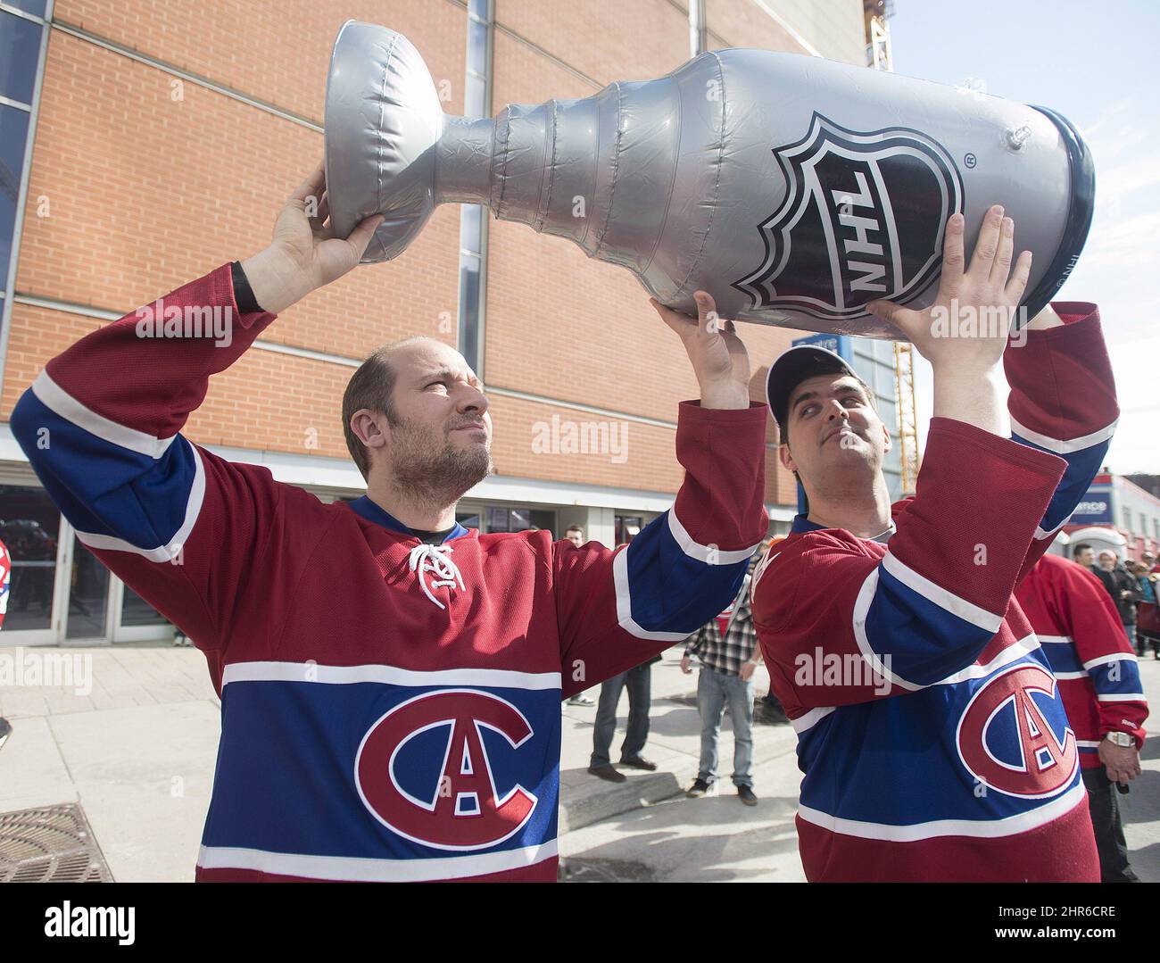 Montreal Canadiens' fans John Tzintzis, left, and Adam Gellert hold up a fake  Stanley Cup prior to game three first round NHL Stanley Cup playoff action  between the Canadiens and the Tampa