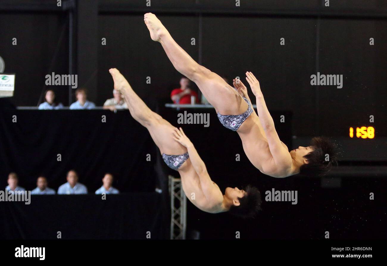 Yong Jin Kim and Haram Woo of Korea perform a dive in the men's open 3m