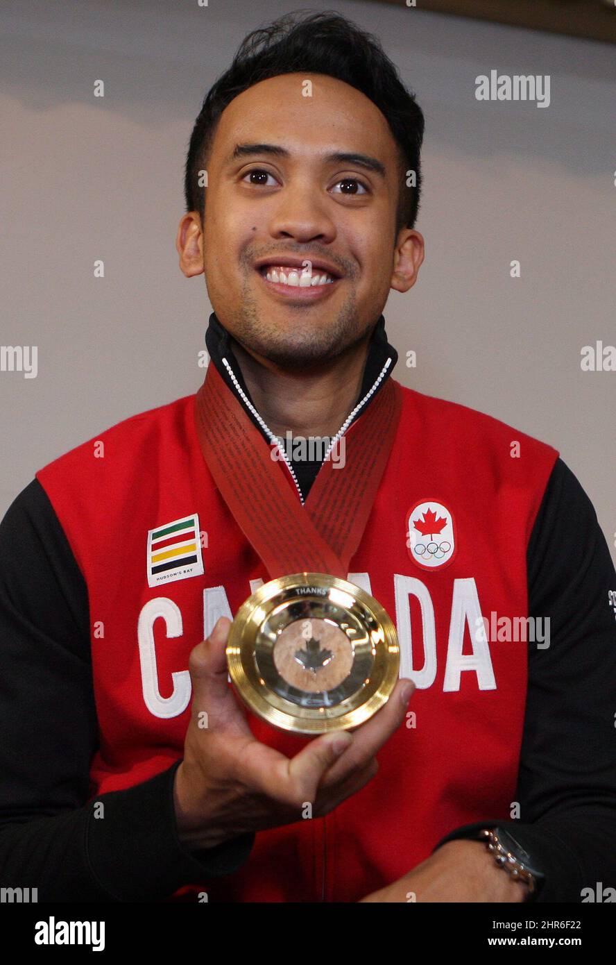 Gimore Junio poses with his medal at King Edward School after he was presented with a commemorative crowdsourced Medal of Thanks in Kitchener, Ont., Wednesday, May 14, 2014. The medal, made of Canadian Maple wood, silver and gold, was conceived by the Toronto design firm Jacknife to thank Junio for his selfless act of stepping aside for teammate Denny Morrison to skate in the 1,000 metre speed skating race at the Sochi Olypics. THE CANADIAN PRESS/Dave Chidley Stock Photo
