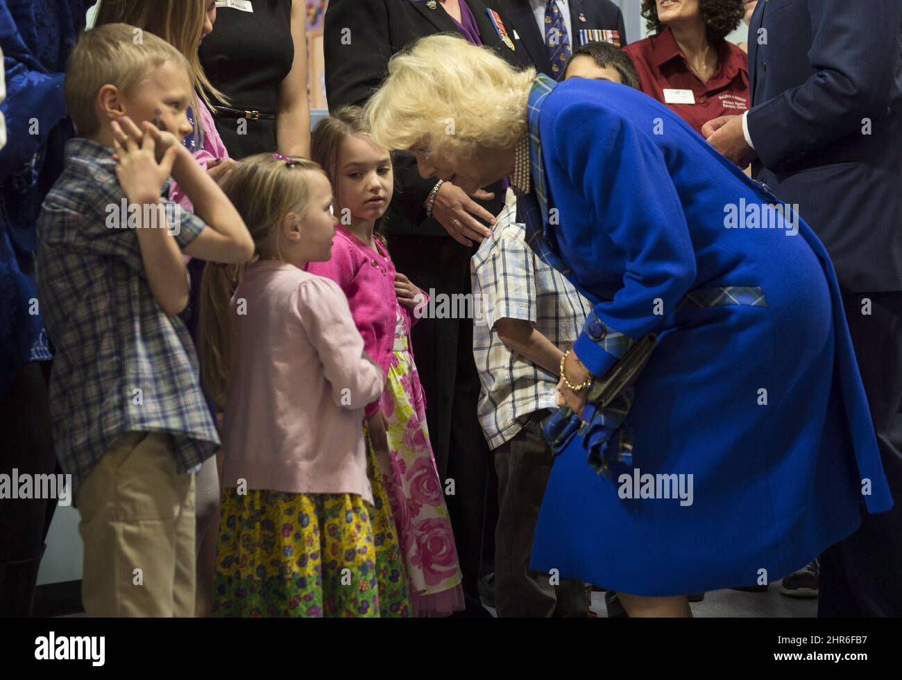 The Duchess of Cornwall greets children while touring a military family centre Monday, May 19