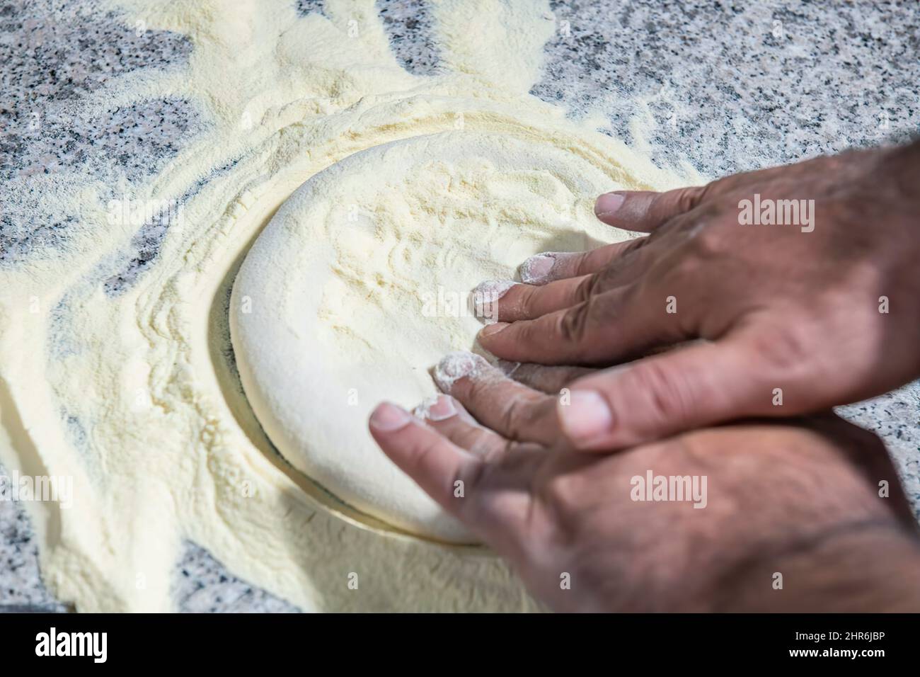 Kneading pizza dough. Italian cuisine. Culinary concept. Pizza