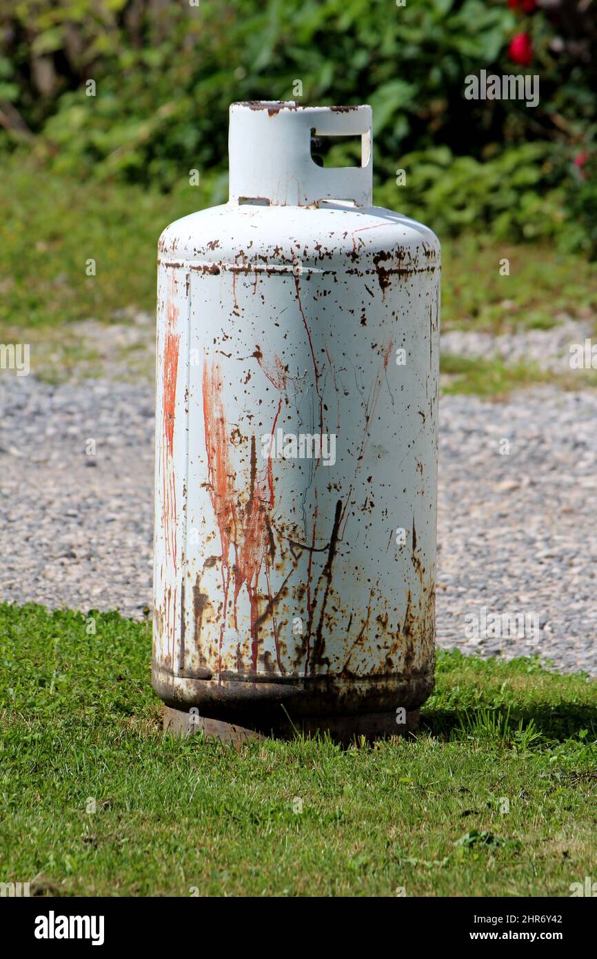 Rusted old light grey propane tank or grill cylinder used for powering