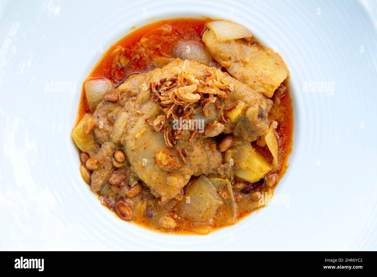 Massaman pork curry on wood background. Thai coconut milk curry. Stock Photo