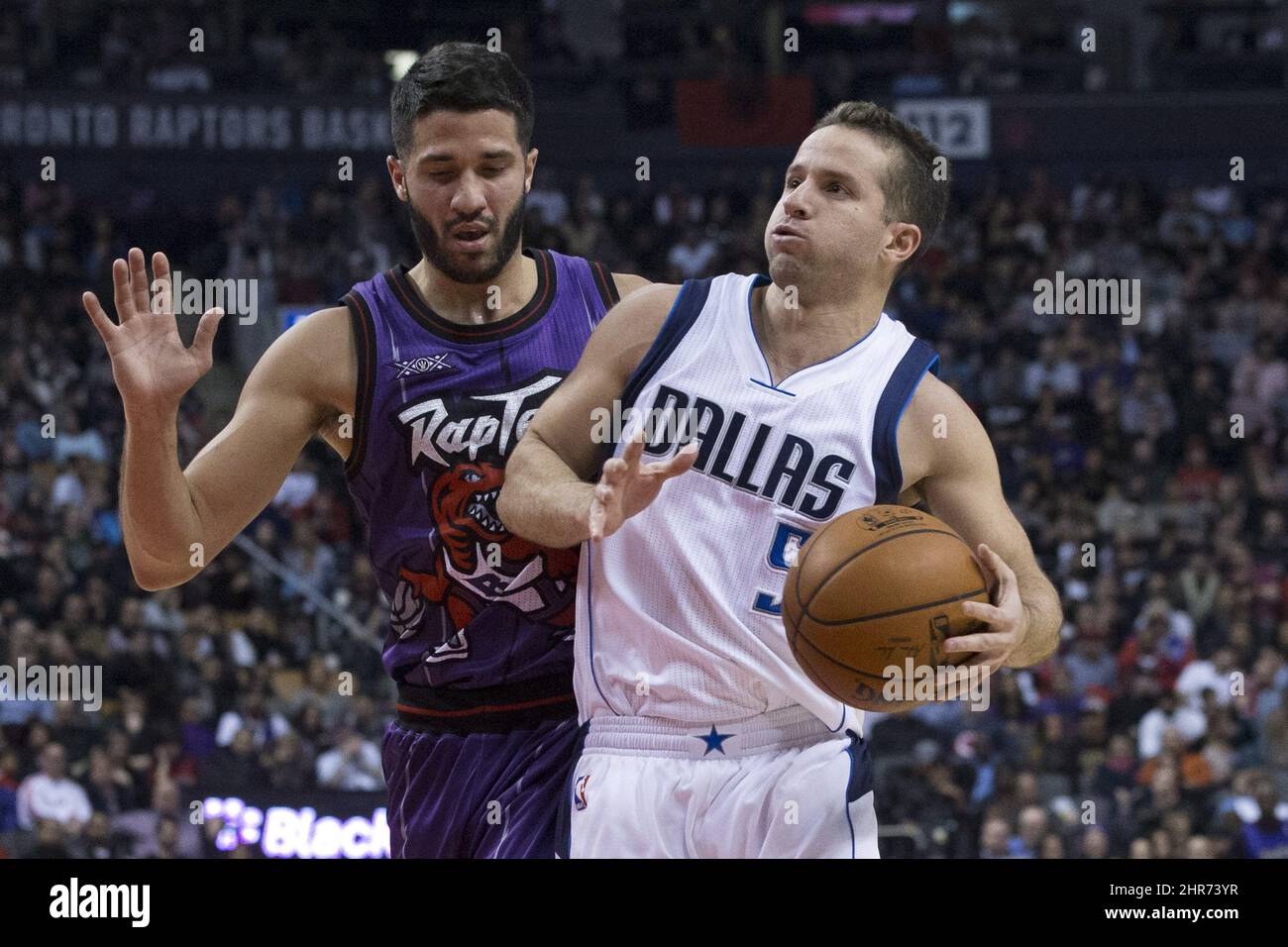Toronto Raptors' Greivis Vasquez smiles from the bench against the  Philadelphia 76ers during the second half of an NBA basketball game in  Toronto on Friday, Dec. 13, 2013. (AP Photo/The Canadian Press
