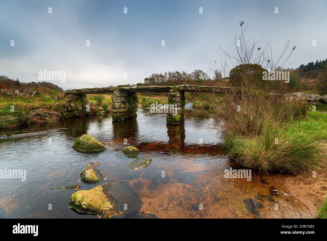 The ancient clapper bridge crossing the East Dart River at Postbridge on Dartmoor National Park in Devon Stock Photo