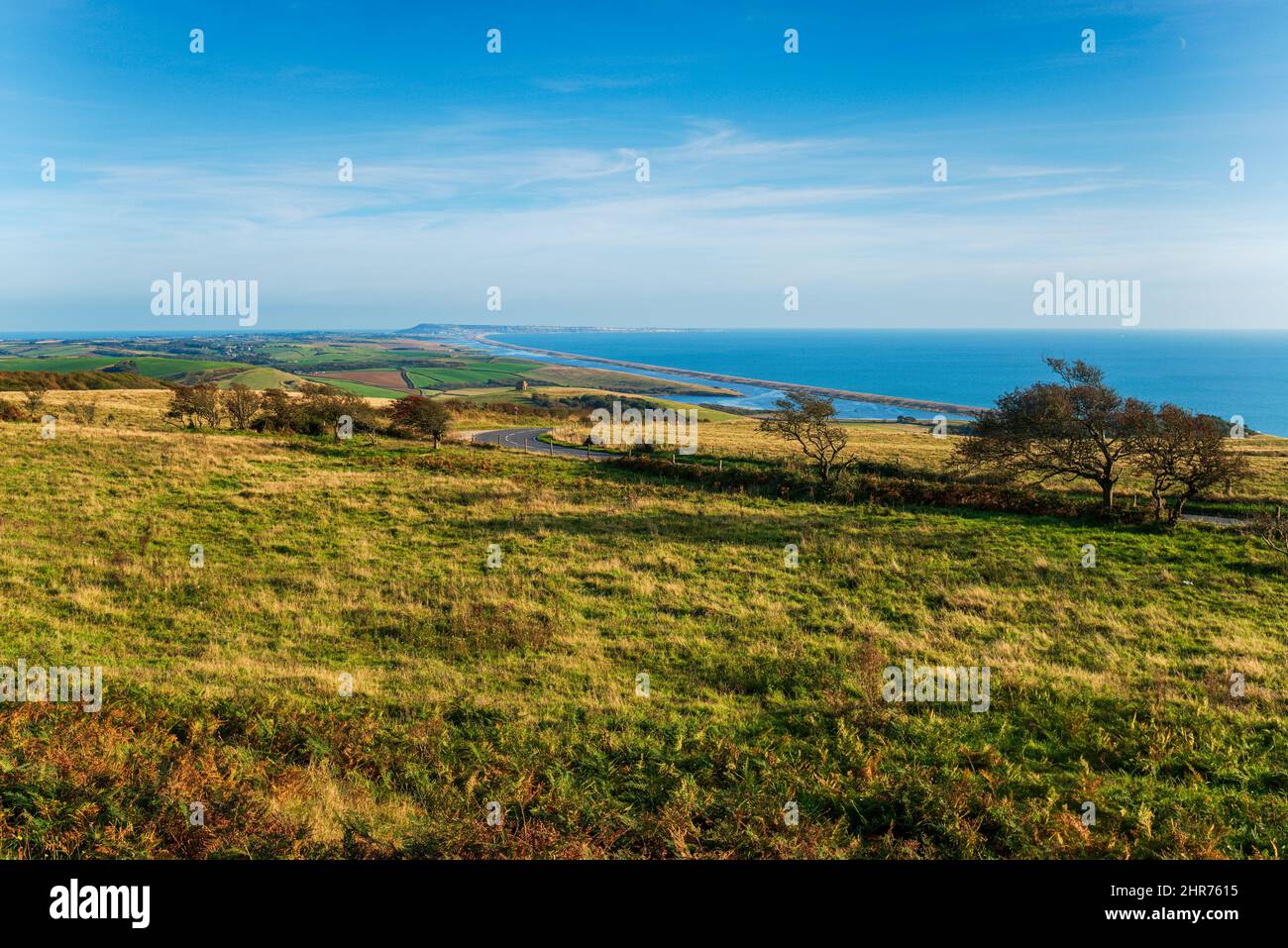 The view from Abbotsbury Hill in Dorset, looking down to the chapel with Chesil Beach and Portland in the far distance Stock Photo