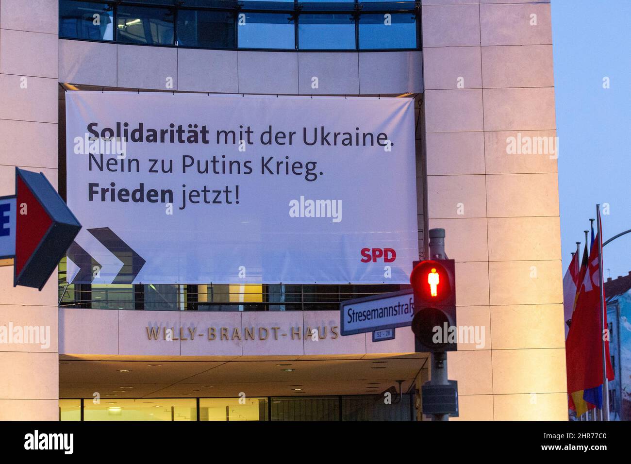 Berlin, Germany. 25th Feb, 2022. A banner with the words 'Solidarity with Ukraine. No to Putin's war. Peace now!' hangs on the facade of the SPD party headquarters. Several Social Democrats have criticized the SPD party leadership's attitude toward former Chancellor Gerhard Schröder. Credit: Fernando Gutierrez-Juarez/dpa-Zentralbild/dpa/Alamy Live News Stock Photo