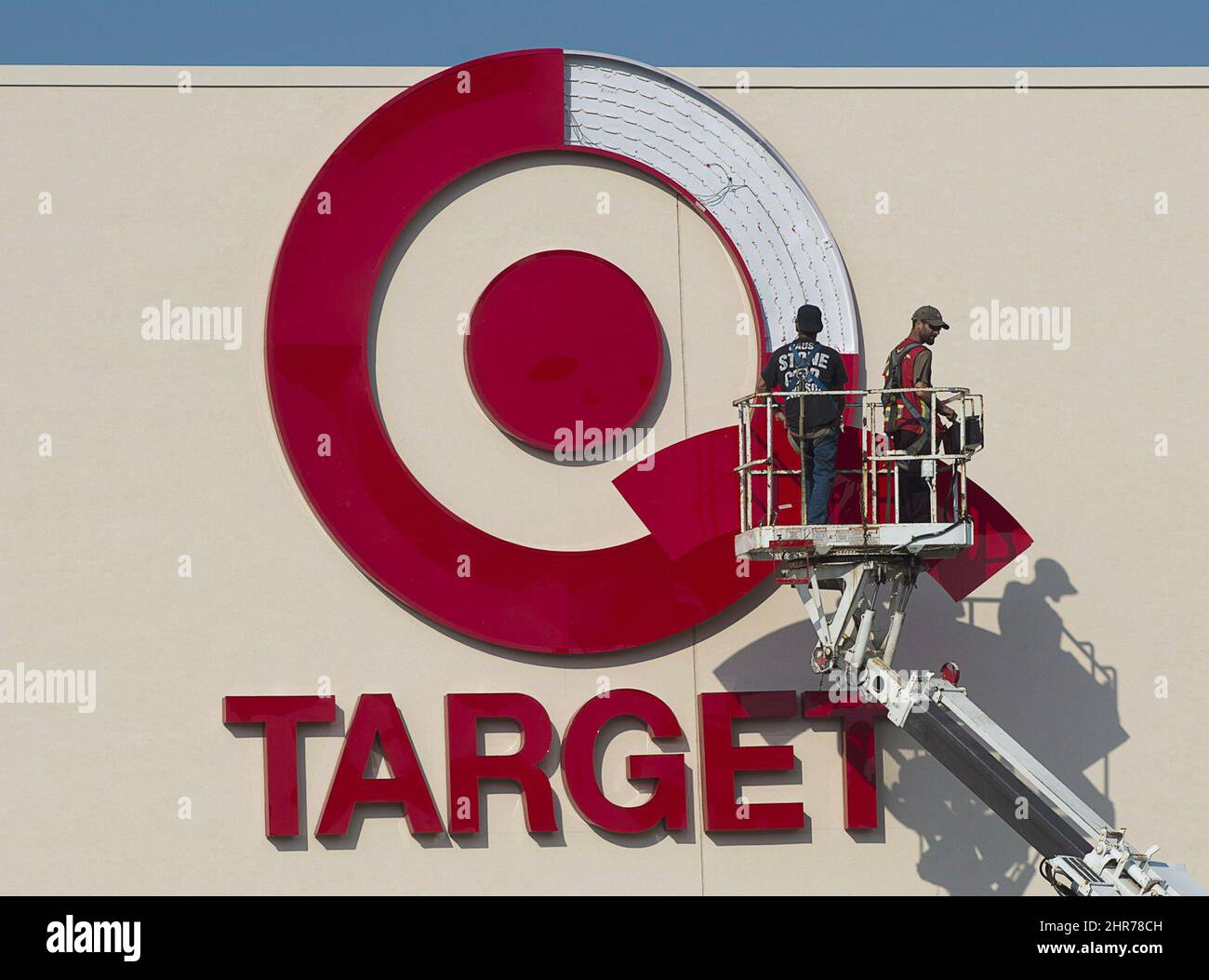 Workers install an outdoor sign at the new Target store at the Mic Mac Mall  in Dartmouth, N.S. on July 20, 2013. Target says it will discontinue  operating stores in Canada. It