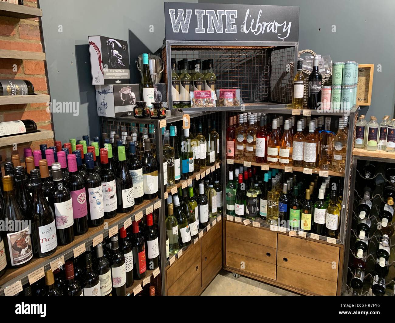 Wine in Farndon Fields farm shop Market Harborough Leicestershire England drink booze library sign signs glass bottle bottles shelving library rack Stock Photo