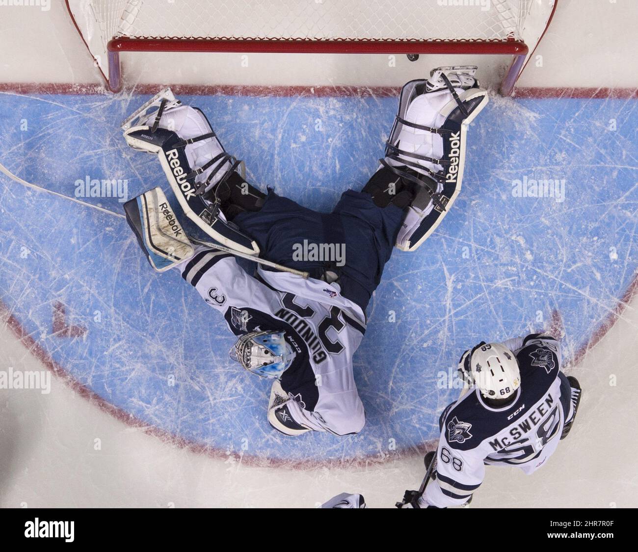 Rimouski Oceanics Louis-Philip Guindon lies on his belly as Kelowna Rockets score a goal during first period action Monday, May 25, 2015 at the Memorial Cup tournament in Quebec City. Rimouski Oceanics Guillaume McSween, right, looks on.THE CANADIAN PRESS/Jacques Boissinot Stock Photo