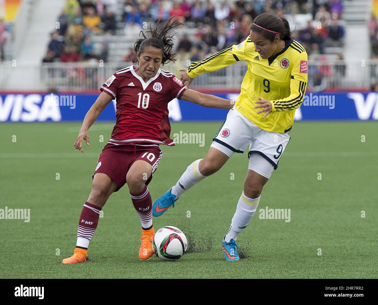 Mexico's Stephany Mayor, left, battles Colombia's Orianica Velasquez during FIFA Women's World Cup first half soccer action in Moncton, N.B. on Tuesday, June 9, 2015. THE CANADIAN PRESS/Andrew Vaughan Stock Photo
