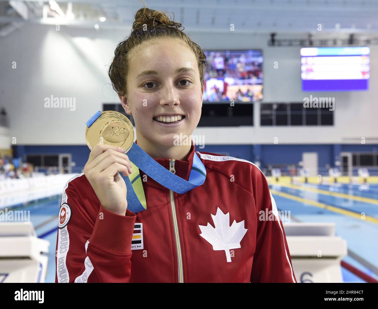 Emily Overholt of Canada shows off her gold medal in the women's 400m freestyle final swimming