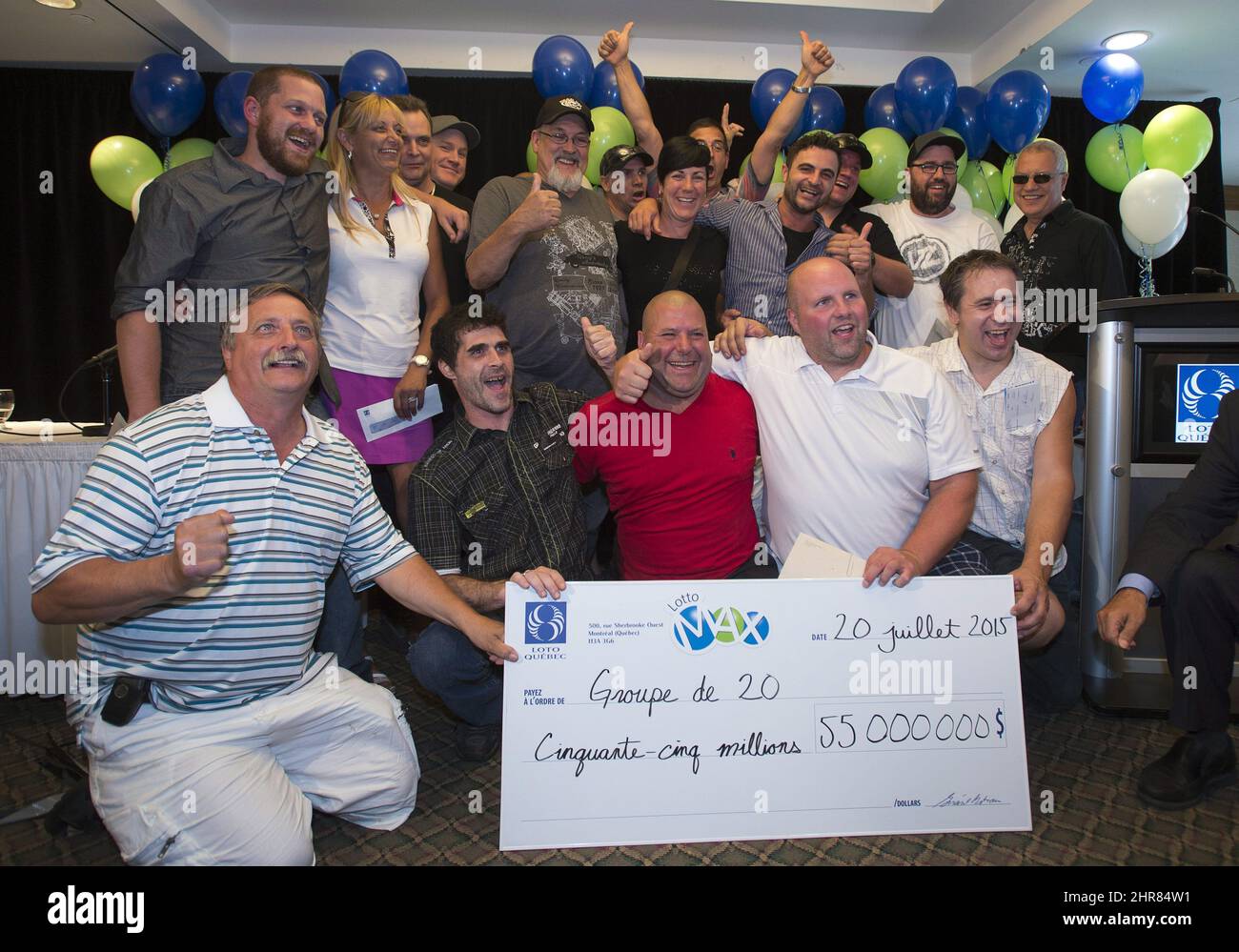 A group of 20 Rona hardware employees pose with their 55 million dollar Lotto Max jackpot cheque, the second largest in Canadian history, at a news conference, Monday, July 20, 2015 in Montreal.THE CANADIAN PRESS/Ryan Remiorz Stock Photo