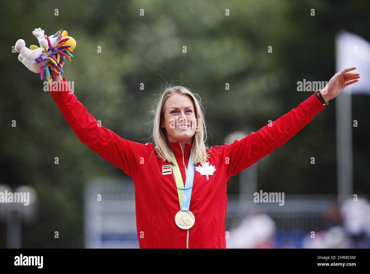 Elizabeth Gleadle of Canada celebrates with her gold medal she won in the  javelin event during the athletics competition at the Pan Am Games in  Toronto, Tuesday July 21, 2015. THE CANADIAN