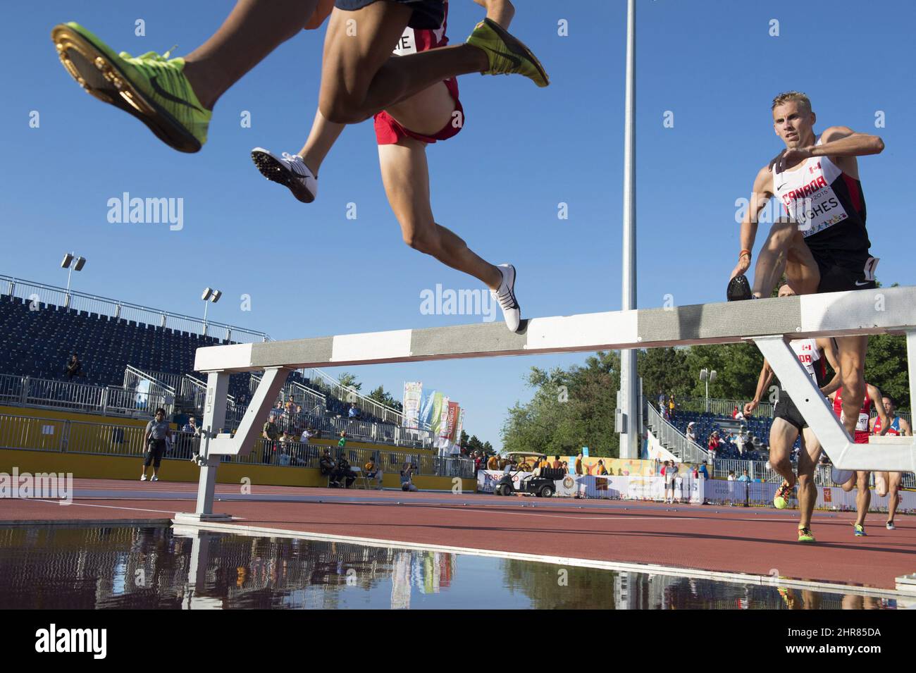 Matt Hughes, of Canada, right, races on his way to a first place finish