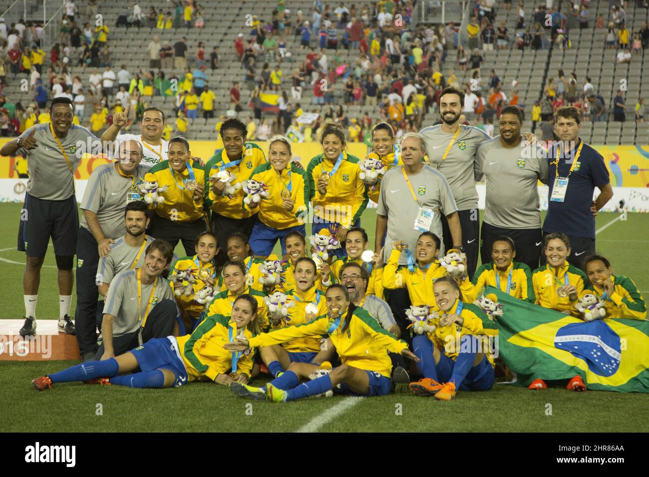 The Brazil women's soccer team pose for a photo with their medals after  winning the 2015 Pan Am Games soccer gold medal by defeating Colombia in  the final game played in Hamilton,, image size:1300x956