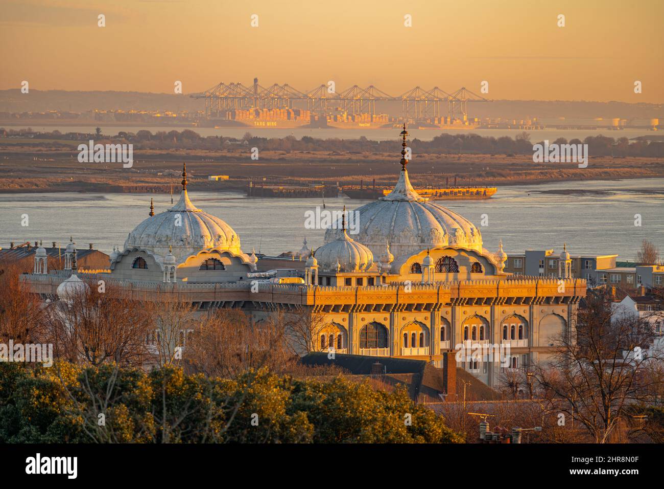Looking towards Thames Gateway port with the domes of the  Guru Nanak Darbar Gurdwara in Gravesend in foreground at dawn Stock Photo