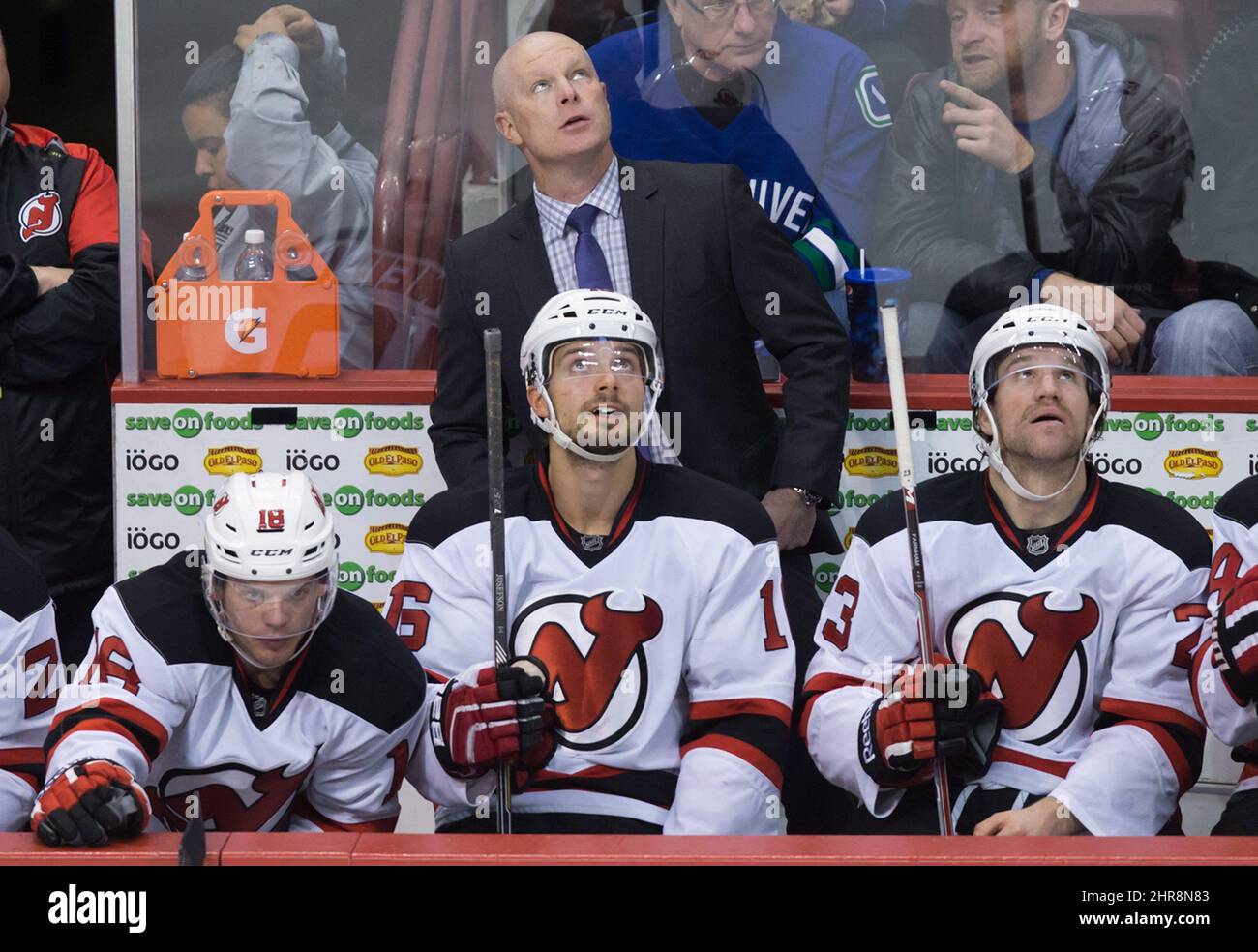 New Jersey Devils' head coach John Hynes, top, stands on the bench