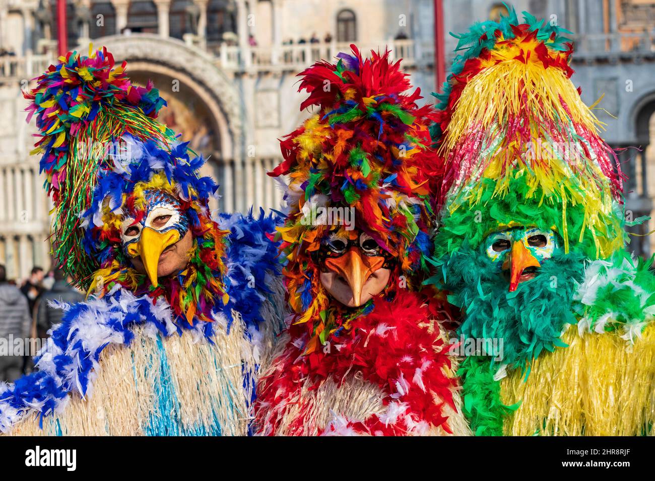 Venice, Italy. 25th Feb, 2022. Colourful costumes at the Carnival in Venice 2022. Three people in colourful chicken costumes in St. Mark's Square. Credit: Vibrant Pictures/Alamy Live News Stock Photo