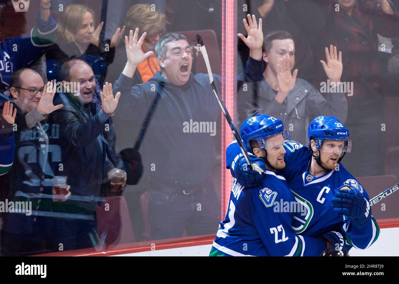 The Vancouver Canucks' Henrik Sedin, right, of Sweden, celebrates with his twin brother Daniel following Daniel's goal against the New York Rangers during third period NHL hockey action, in Vancouver, on Wednesday, Dec. 9, 2015. Two years ago under John Tortorella, the Vancouver Canucks' superstars had one of their worst seasons in recent memory, but the twins are back putting up big numbers this season. THE CANADIAN PRESS/Darryl Dyck Stock Photo