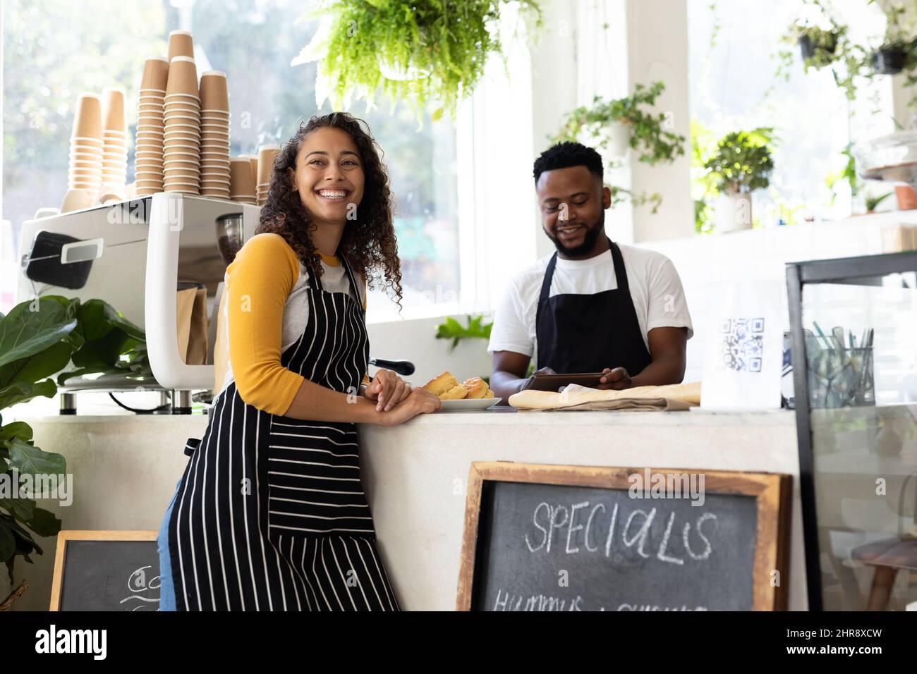 Young african american barista coworkers standing at counter in coffee shop Stock Photo