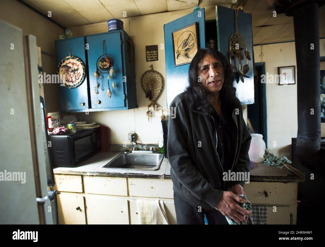 Louis Okimaw stands in the kitchen of his house which has been deemed