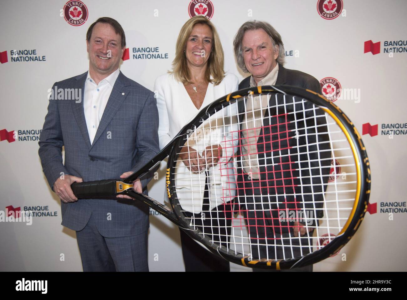 National Bank president and CEO Louis Vachon, Tennis Canada president and  CEO Kelly Murumets and vice-president Eugene Lapierre pose for a photo  after announcing a renewed partnership for a six-year term Tuesday,