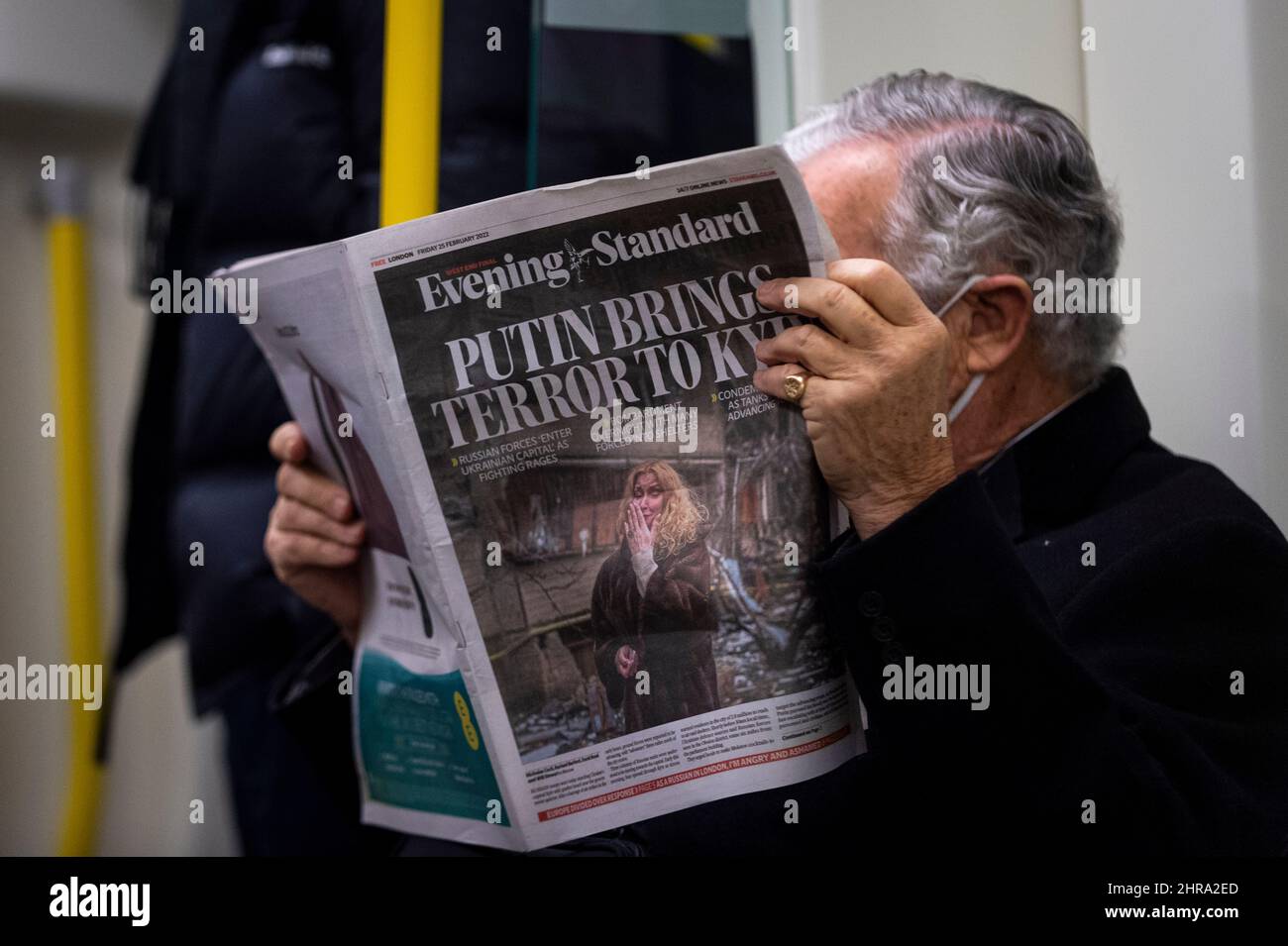 London, UK. 25th Feb, 2022. A man reads on the tube reads The Evening Standard which carries a headline about Russia's invasion of Ukraine and the entry into Kiev, the capital. Credit: Stephen Chung/Alamy Live News Stock Photo