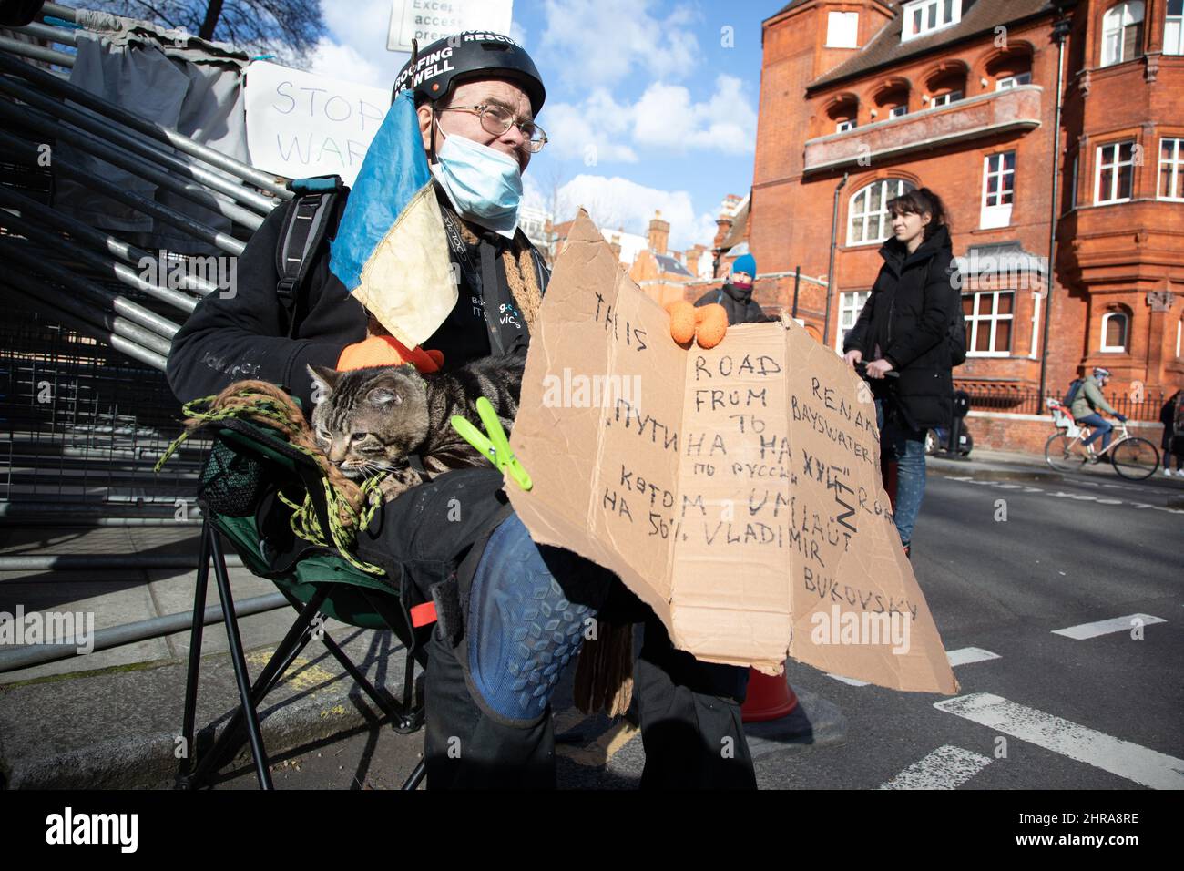 London, UK. 25th Feb, 2022. A man and his cat protest outside the Russian Embassy in London against Russia's recent attack on the Ukraine. Credit: Kiki Streitberger/Alamy Live News Stock Photo