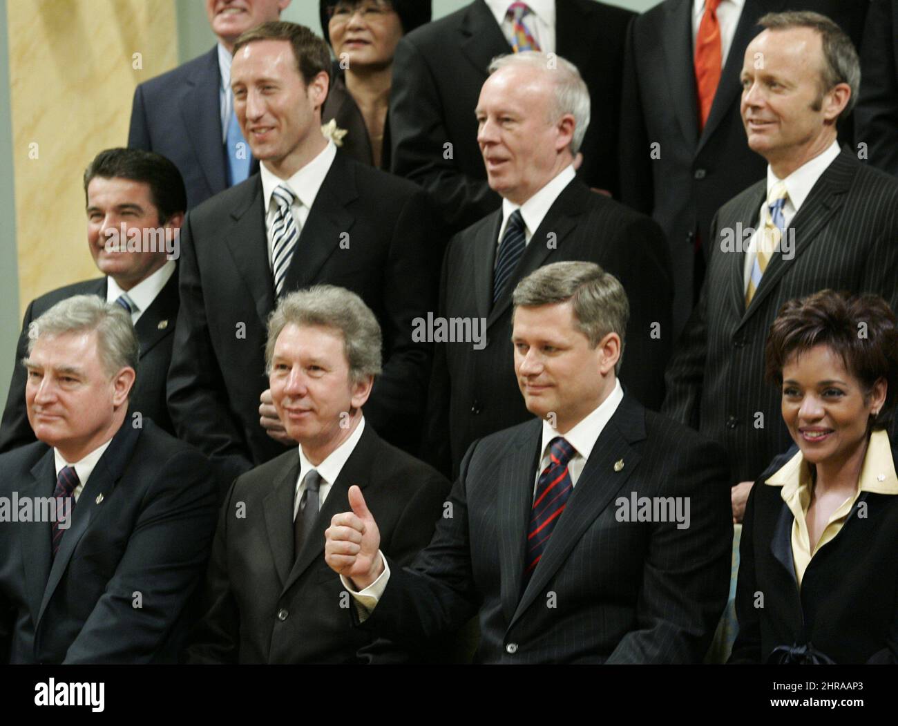 Prime Minister Stephen Harper (bottom row, second from right) gives the thumbs as he and members of his new cabinet pose for a photograph with Governor General Michaelle Jean (bottom row, far right) after a swearing-in ceremony in Ottawa, Monday, Febuary 6, 2006. Front row (left to right) David Emerson, Minister of International Trade and Pacific Gateway and the Vancouver-Whistler Olympics, Jean-Pierre Blackburn, Minister of Labour and Minister of the Economic Development Agency of Canada for the Regions of Quebec, Prime Minister Harper, Governor General Michaelle Jean. Back row (left to right Stock Photo