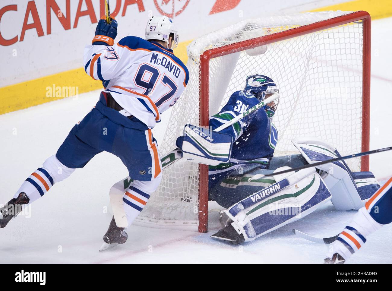Edmonton Oilers' Connor McDavid, left, scores against Vancouver Canucks ...