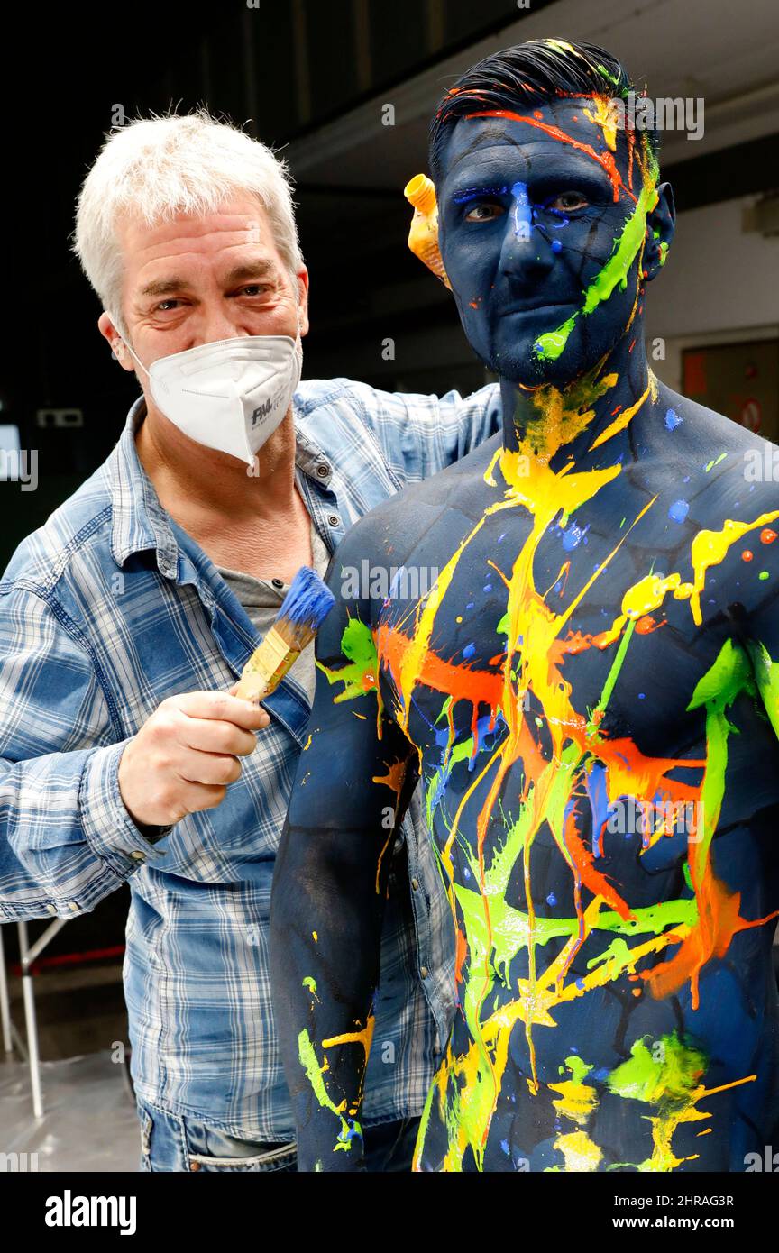Bodyart artist Jörg Düsterwald has created a series of works of art on the subject of 'diversity' with various photo model types. In the production halls of the cooperating company Vorwerk flooring in Hamelin, he provided the male model Michael with body painting to match the sponsored floor covering and then applied traces of liquid paint. Stock Photo