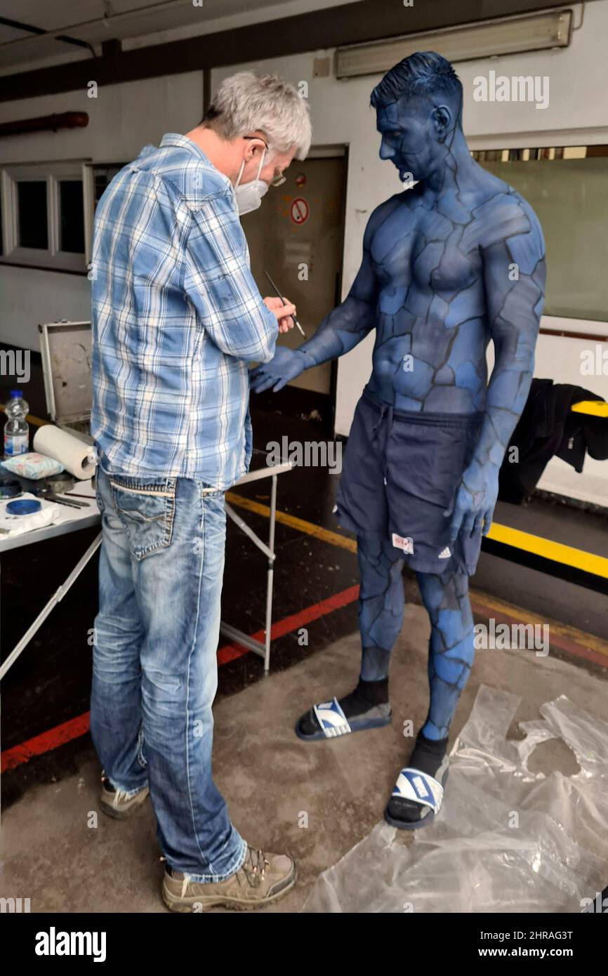 Bodyart artist Jörg Düsterwald has created a series of works of art on the subject of 'diversity' with various photo model types. In the production halls of the cooperating company Vorwerk flooring in Hamelin, he provided the male model Michael with body painting to match the sponsored floor covering and then applied traces of liquid paint. Stock Photo
