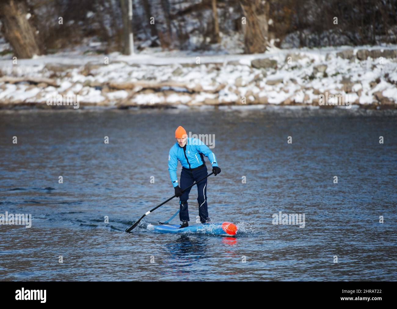 Olympic gold medalist Larry Cain, 53, stand up paddles in the frigid