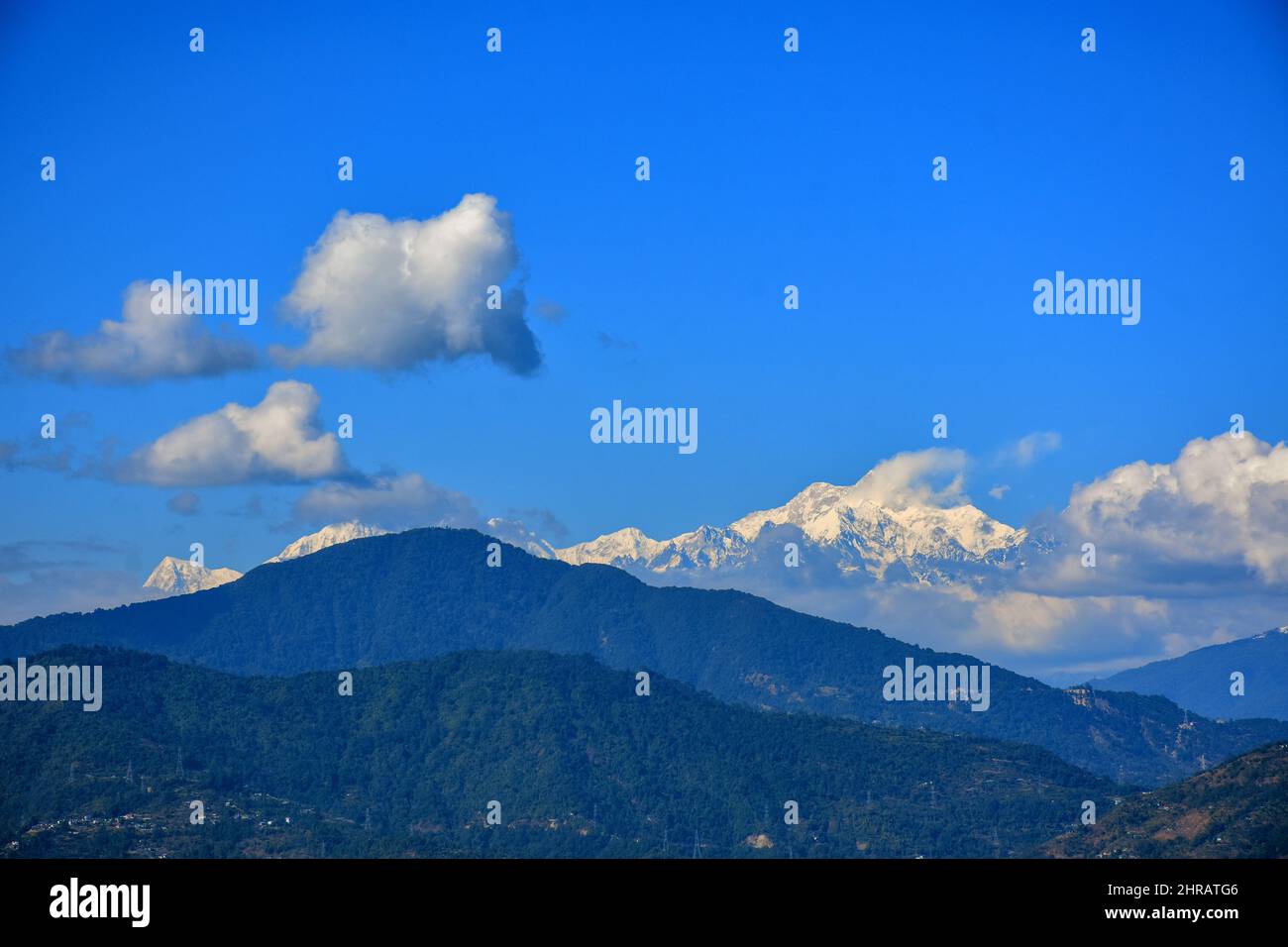 Mountain ridges in the clouds with Mt. Kanchenjunga range Stock Photo