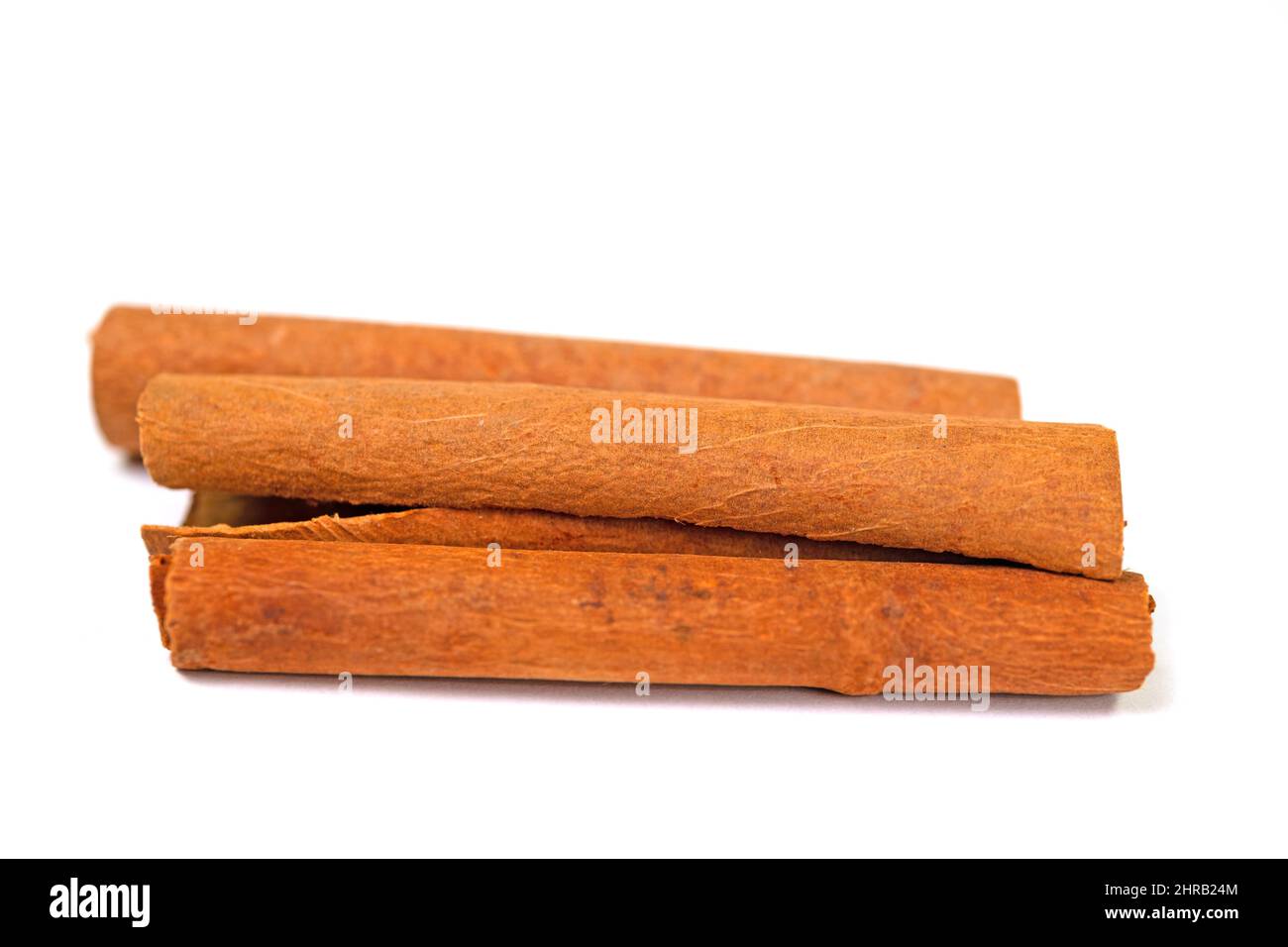 Cinnamon sticks isolated against white background Stock Photo