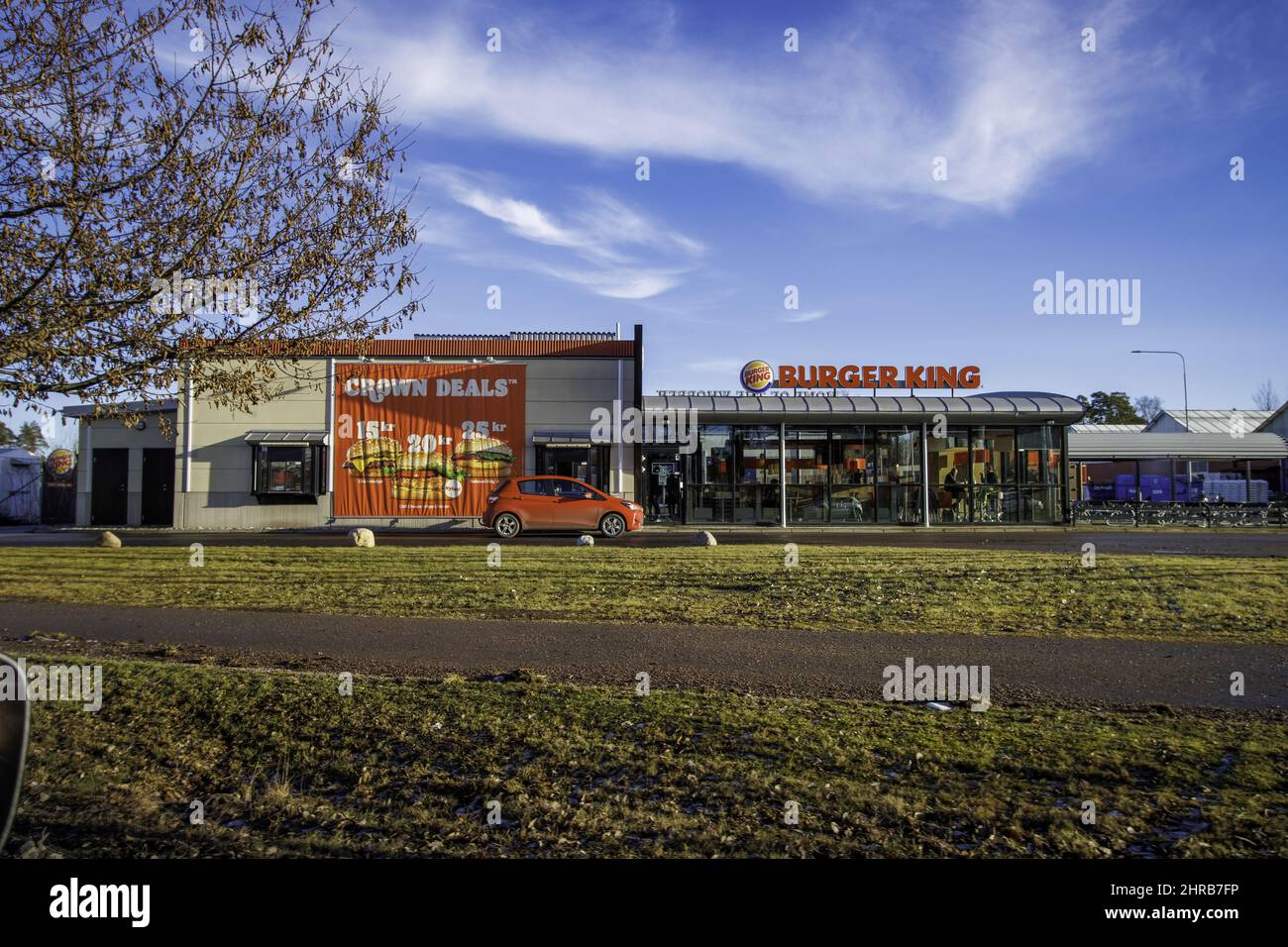 Frontal shot of the Burger King fast-food next to Crown Deals burger store in Motala, Sweden. Stock Photo