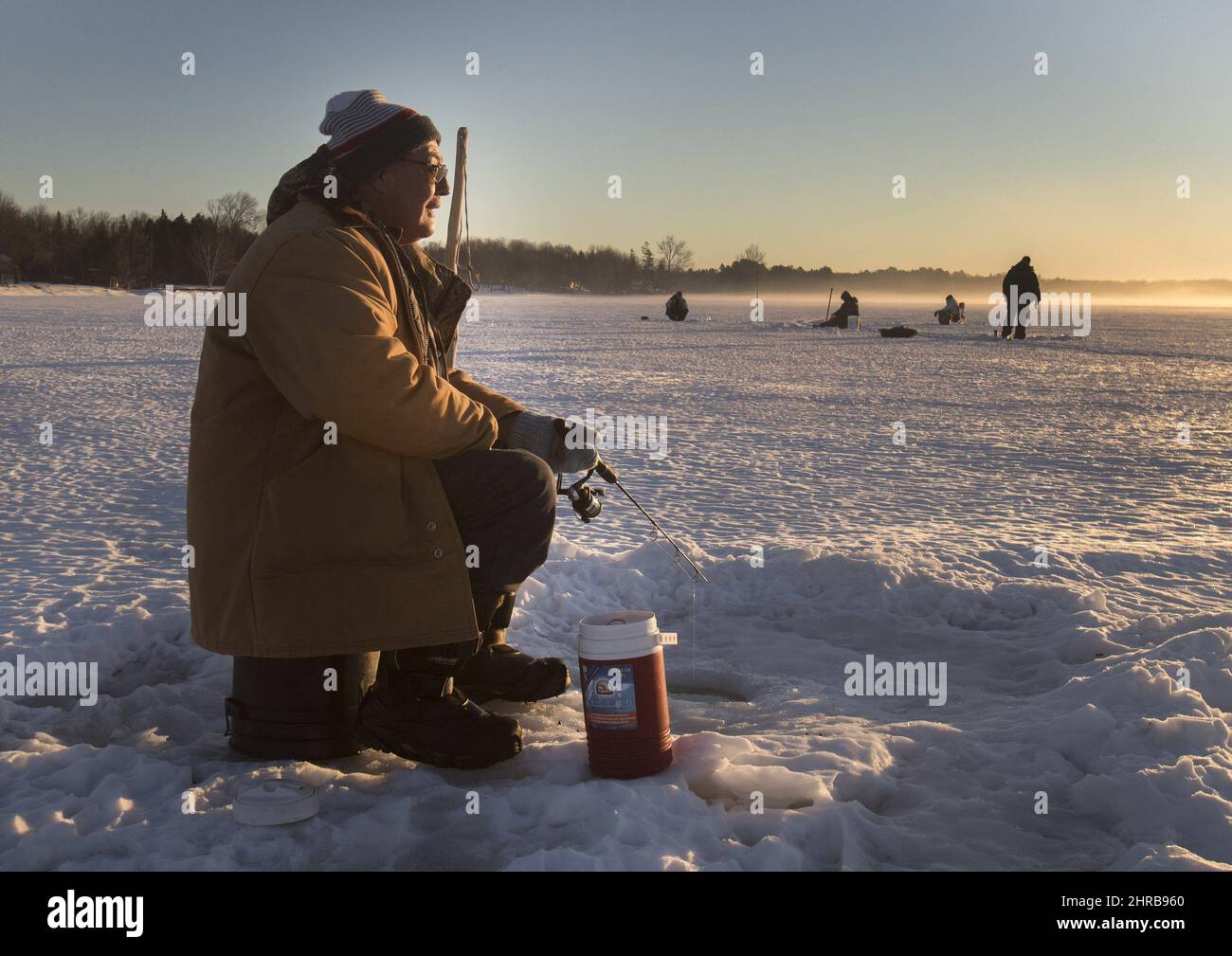 An ice fisherman fishes on Pigeon Lake, in the Kawartha's region of central Ontario on Sunday