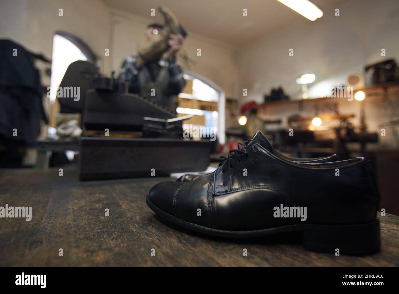 Olde Town Shoe Repair owner Mike Waterman works on other shoes as