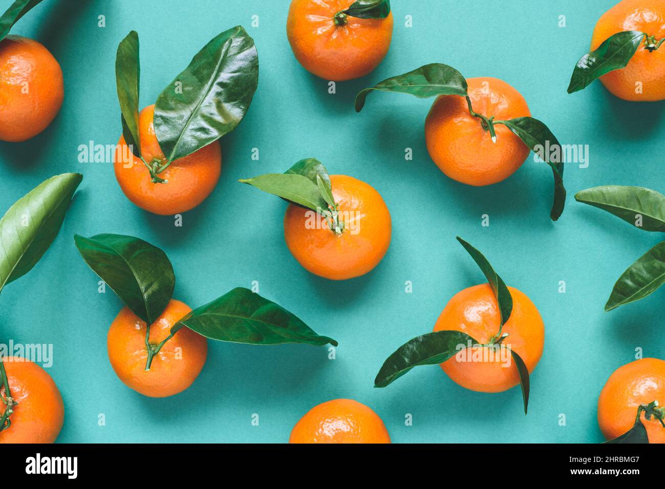 Fresh mandarins with leaves on turquoise background Stock Photo Alamy