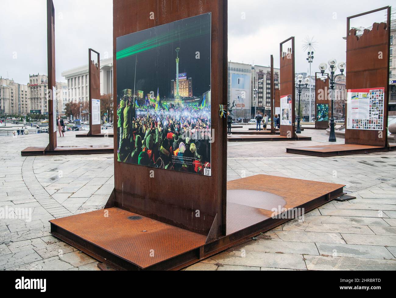People walk around the exhibition memorizing the 2014 protest at the Independence Square (Maidan Nezalezhnosti) in central Kiev. Stock Photo
