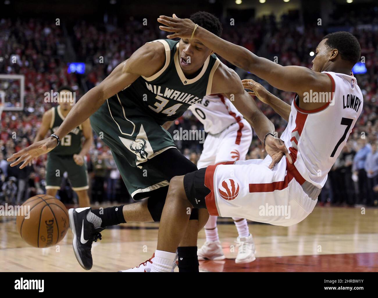 Toronto Raptors guard Kyle Lowry (7) goes down as Milwaukee Bucks forward Giannis Antetokounmpo (34) drives during the second half of Game 2 of an NBA basketball first-round playoff series, Tuesday, April