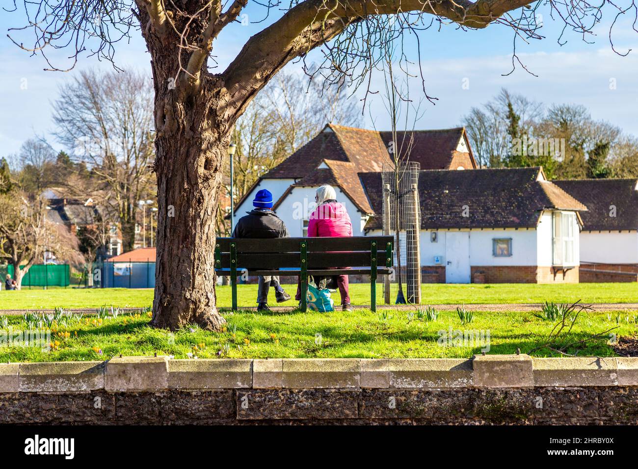 Two people sitting on a park bench talking at Bancroft Splash Park